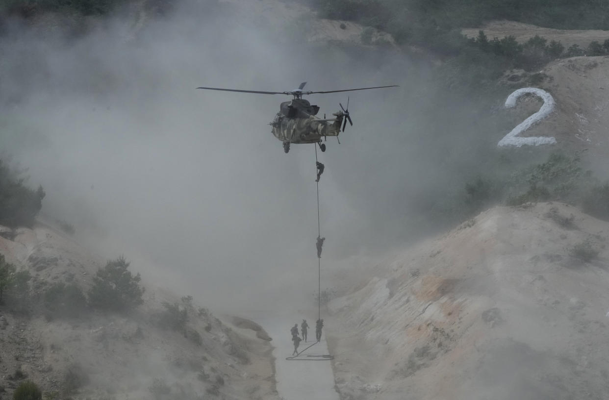 South Korean army soldiers rappel down from a Surion helicopter during South Korea-U.S. joint military drills at Seungjin Fire Training Field in Pocheon, South Korea, Thursday, May 25, 2023. (AP Photo/Ahn Young-joon)