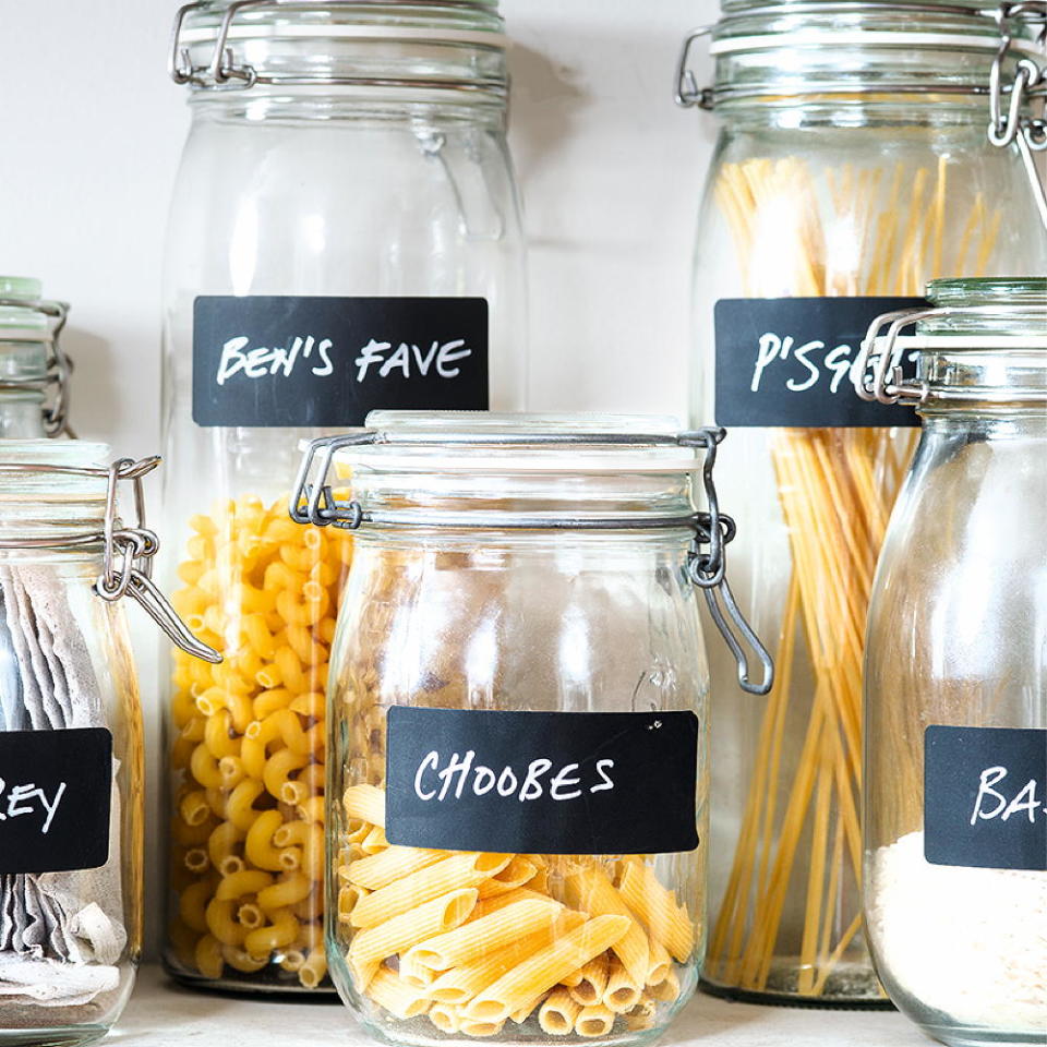 various pasta in glass canister with chalkboard labels