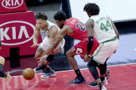 Boston Celtics' Carsen Edwards, left, and Mattel's Chicago Bulls' Thaddeus Young (21) go for the ball as Celtics' Robert Williams III watches during the first half of an NBA basketball game Monday, Jan. 25, 2021, in Chicago. (AP Photo/Charles Rex Arbogast)