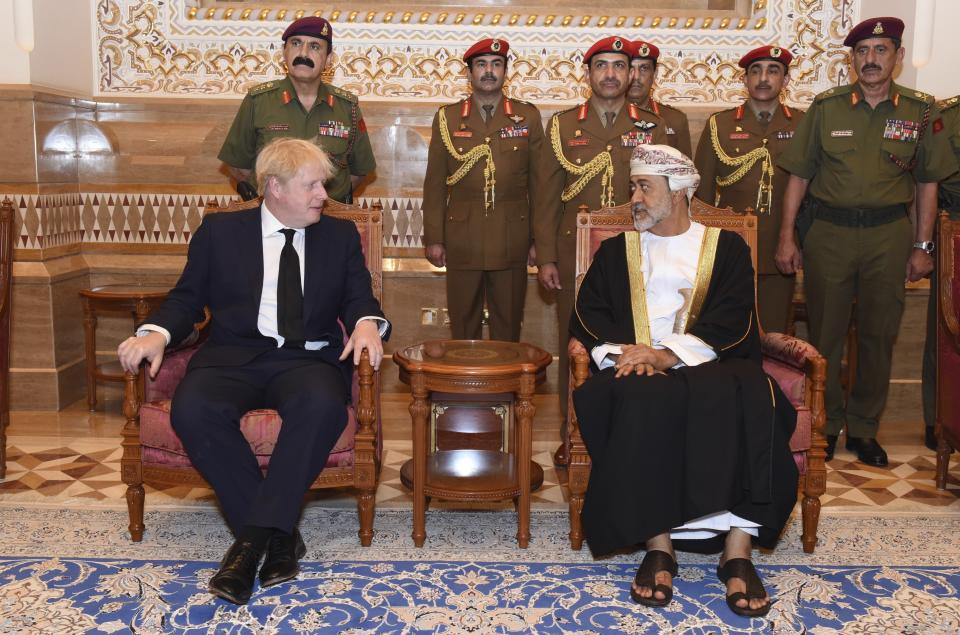 In this photo made available by Oman News Agency, Oman's new sultan Haitham bin Tariq Al Said, right, receives Britain's Prime Minister Boris Johnson after his arrival to attend an official mourning ceremony for the late Sultan Qaboos, in Muscat, Oman, Sunday, Jan. 12, 2020. (Oman News Agency via AP)