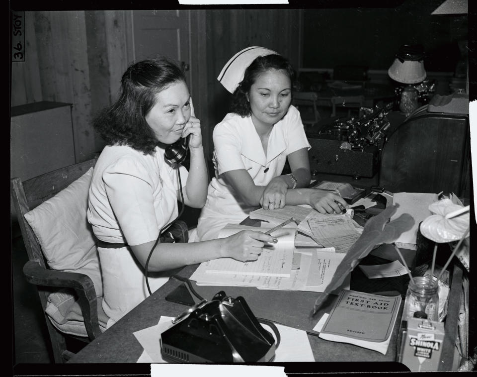 A newspaper photo shows two Japanese-American workers at an emergency medical unit in Honolulu, with the caption saying they are "typical of the loyal Japanese-Americans in the Islands; they have been on continuous duty since the attack on December 7." (Photo: Bettmann via Getty Images)