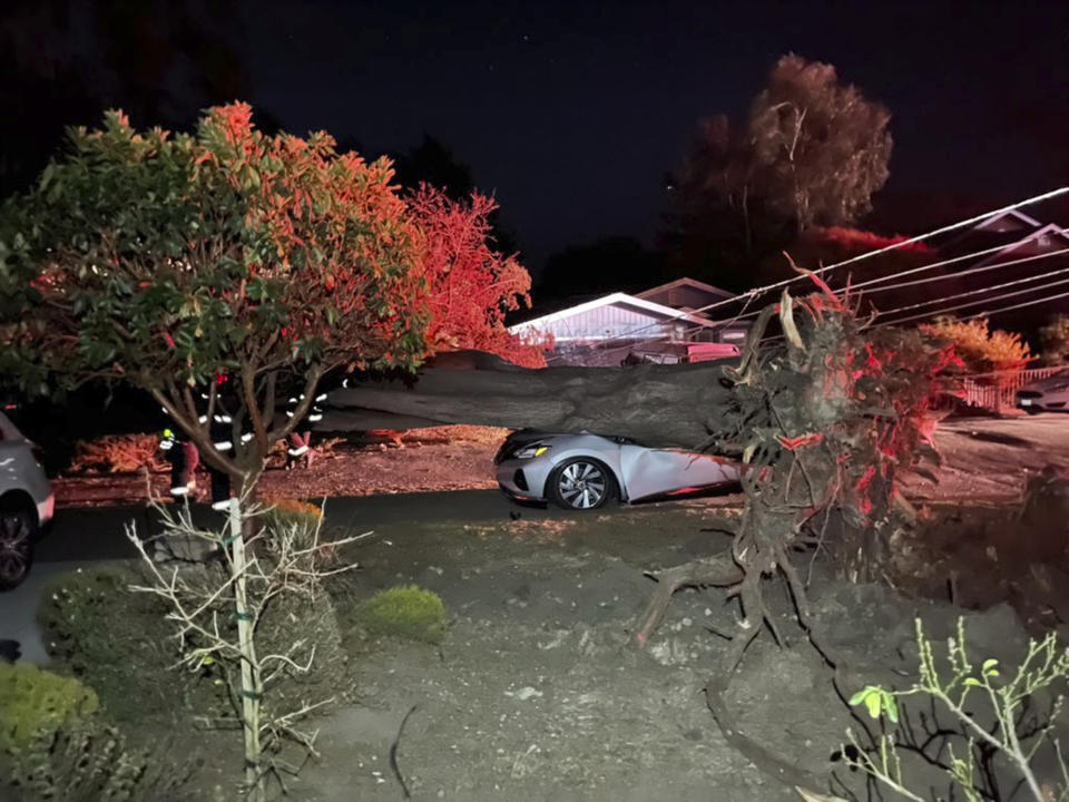 This early Monday, Oct. 11, 2021, photo provided by CalFire shows one of several vehicles damaged during a wind event in El Granada village in the coastal area of northern San Mateo County, Calif. (CalFire via AP)