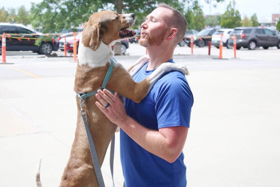 Furry Kids Refuge volunteer Travis Kramer of Lee’s Summit gets a big hello from Maple at the weekly adoption event at Petco in Lee’s Summit. Beth Lipoff/Special to the Journal