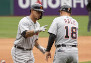 Detroit Tigers' Wilson Ramos, left, is congratulated by third base coach Chip Hale, right, after hitting a solo home run during the seventh inning of a baseball game in Cleveland, Sunday, April 11, 2021. (AP Photo/Phil Long)