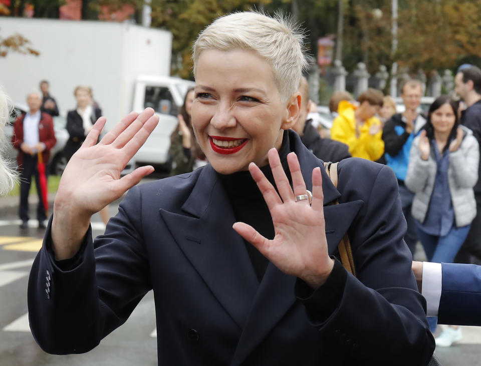 Maria Kolesnikova, one of Belarus' opposition leaders, gestures on the way to the Belarusian Investigative Committee in Minsk, Belarus, Thursday, Aug. 27, 2020. Police in Belarus detained over 50 people across the country during protests demanding the resignation of Belarus' authoritarian leader, officials said Wednesday. (AP Photo/Dmitri Lovetsky)