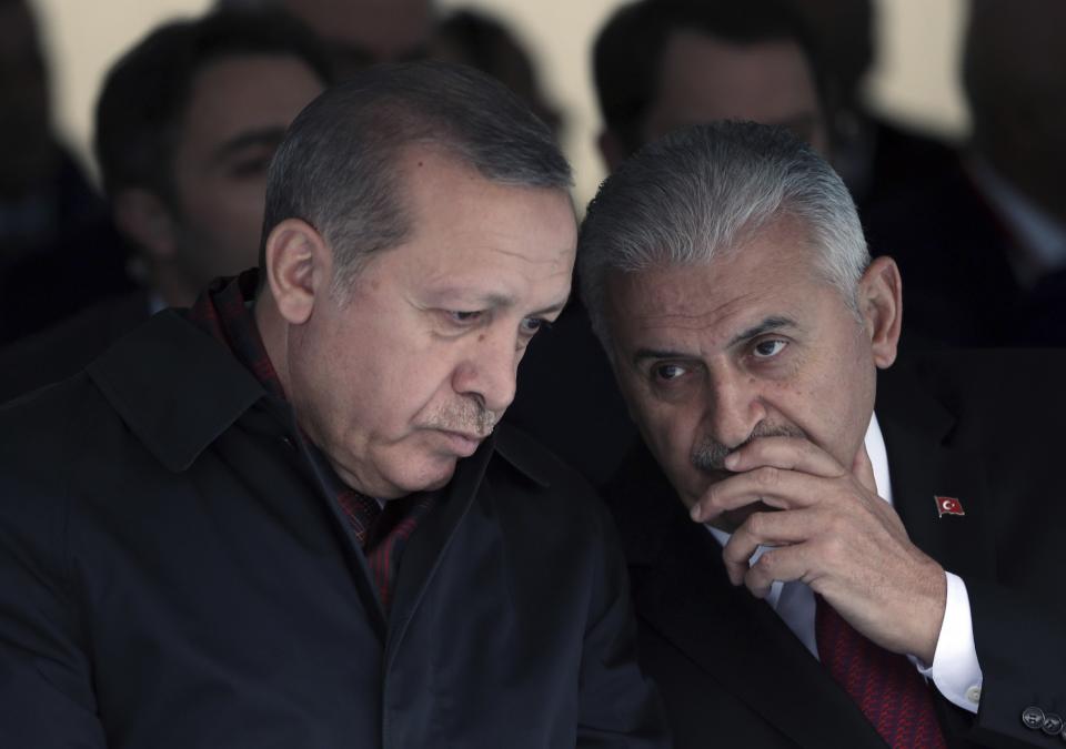 <p>Turkey’s President Recep Tayyip Erdogan, left, and Prime Minister Binali Yildirim talk during a ceremony for a new train station building on Republic Day in Ankara, Turkey, Saturday, Oct. 29, 2016. (AP Photo/Burhan Ozbilici) </p>