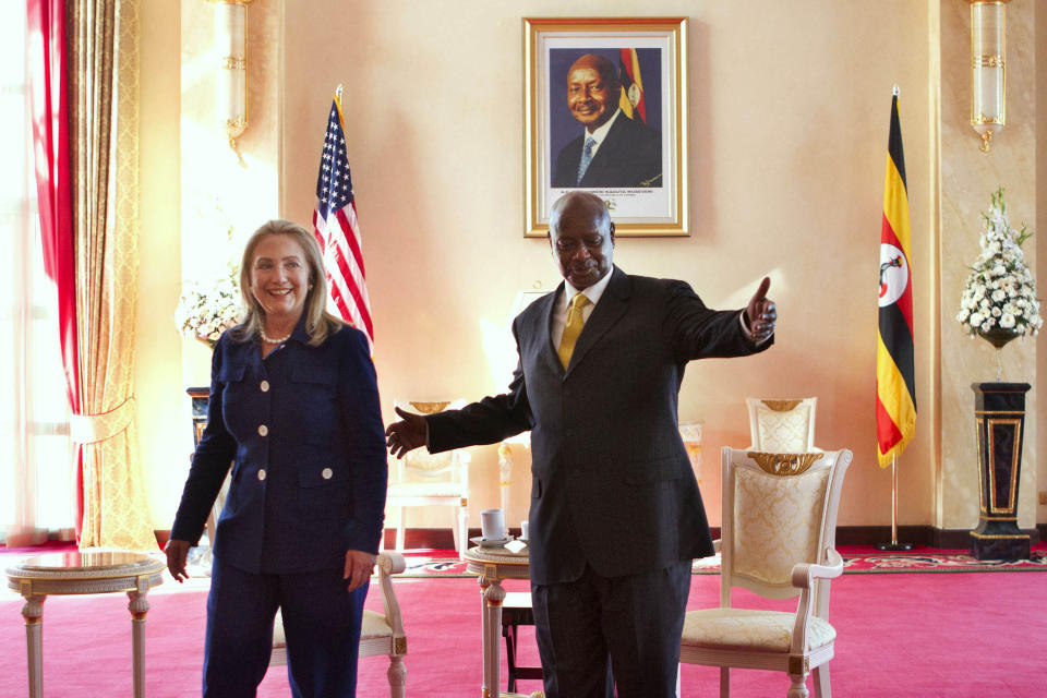 FILE - In this Friday, Aug. 3, 2012 file photo, Secretary of State Hillary Rodham Clinton, left, meets with Ugandan President Yoweri Museveni, right, at the State House in Kampala, Uganda. Ugandan President Yoweri Museveni met in his office with a team of U.S.-based rights activists concerned about legislation that would impose life sentences for some homosexual acts and made clear he had no plans to sign the bill, according to Santiago Canton of the Robert F. Kennedy Center for Justice and Human Rights who attended the Jan. 18, 2014 meeting, but one month later Museveni appears to have changed his mind, saying through a spokesman in February 2014 that he would sign the bill "to protect Ugandans from social deviants." (AP Photo/Jacquelyn Martin, Pool, File)