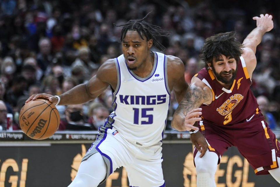 Sacramento Kings' Davion Mitchell (15) drives against Cleveland Cavaliers' Ricky Rubio during the second half of an NBA basketball game Saturday, Dec. 11, 2021, in Cleveland. The Cavaliers won 117-103. (AP Photo/Tony Dejak)