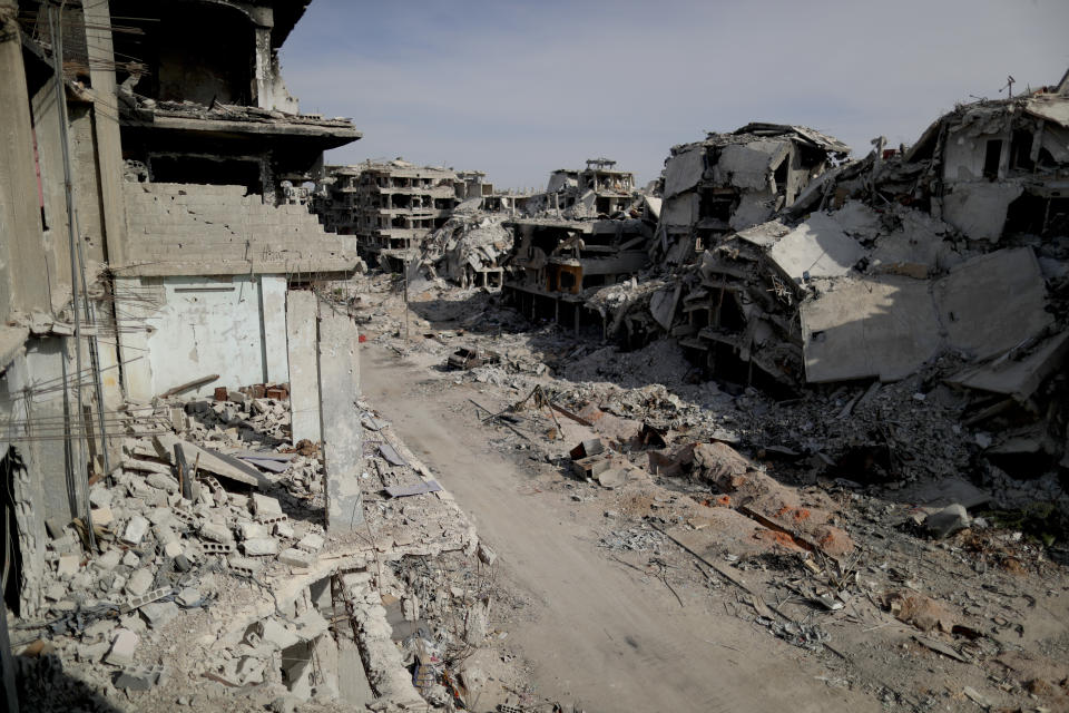 Buildings lie in ruins in the Palestinian refugee camp of Yarmouk in the Syrian capital Damascus, Syria, Saturday, Oct. 6, 2018. The camp, once home to the largest concentration of Palestinians outside the territories housing nearly 160,000 people, has been gutted by years of war. (AP Photo/Hassan Ammar)
