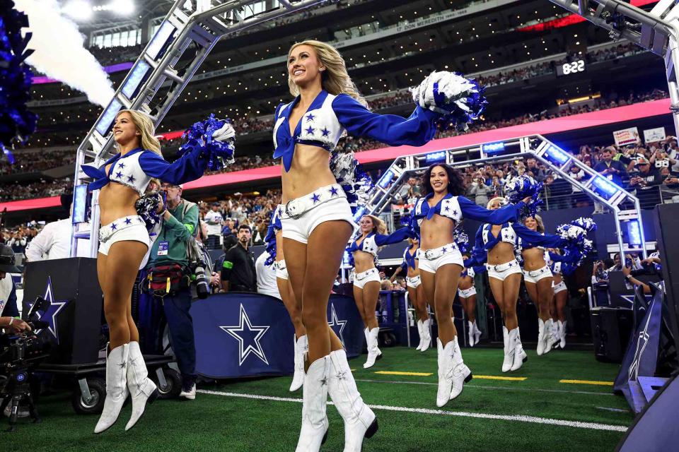 <p>Kevin Sabitus/Getty</p> Dallas Cowboys cheerleaders dance prior to an NFL football game against the Washington Commanders at AT&T Stadium on November 23, 2023 in Arlington, Texas.