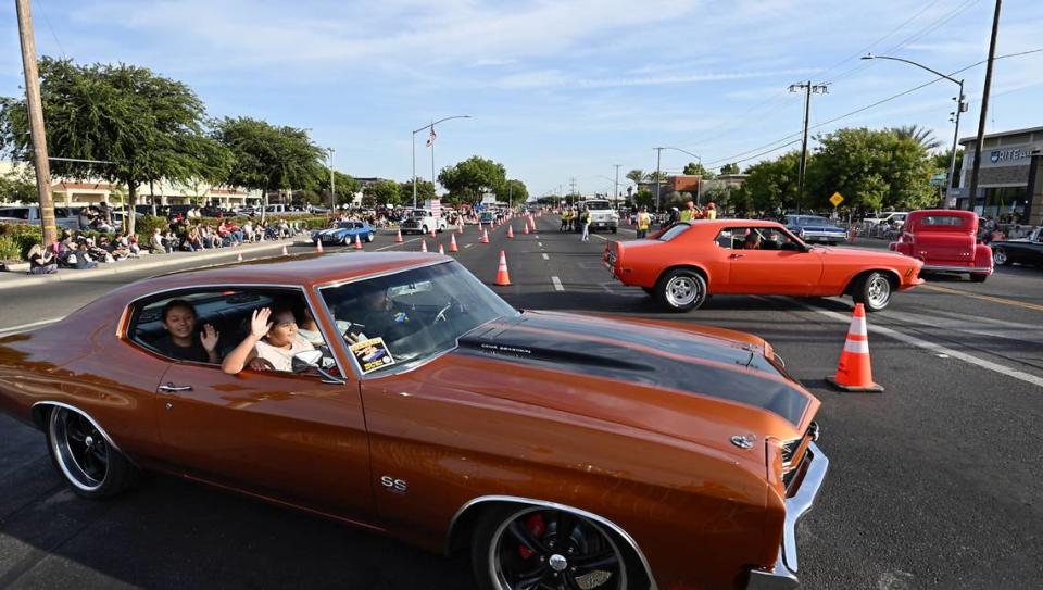 Classic car owners make the turn at Briggsmore and McHenry Avenues during the Graffiti Parade in Modesto, Calif., Friday, June 9, 2023. Andy Alfaro/aalfaro@modbee.com