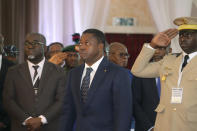 Togo's President, Faure Gnassingbé Eyadéma, centre, looks on, prior to the start of the ECOWAS meeting, in Abuja, Nigeria, Saturday, Feb. 24, 2024. Heads of state across West Africa met on Saturday to discuss the region's existential challenges with a renewed plea on junta-led nations to rescind their decision to quit the regional bloc and a plan to review of sanctions it imposed to reverse the coup in Niger. (AP Photo/Gbemiga Olamikan)