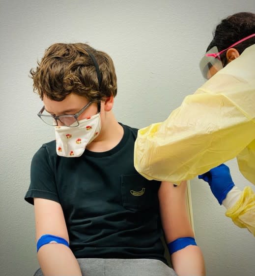 Otto Staudenmaier receives an injection during the Moderna trial for children aged 12 to 17.