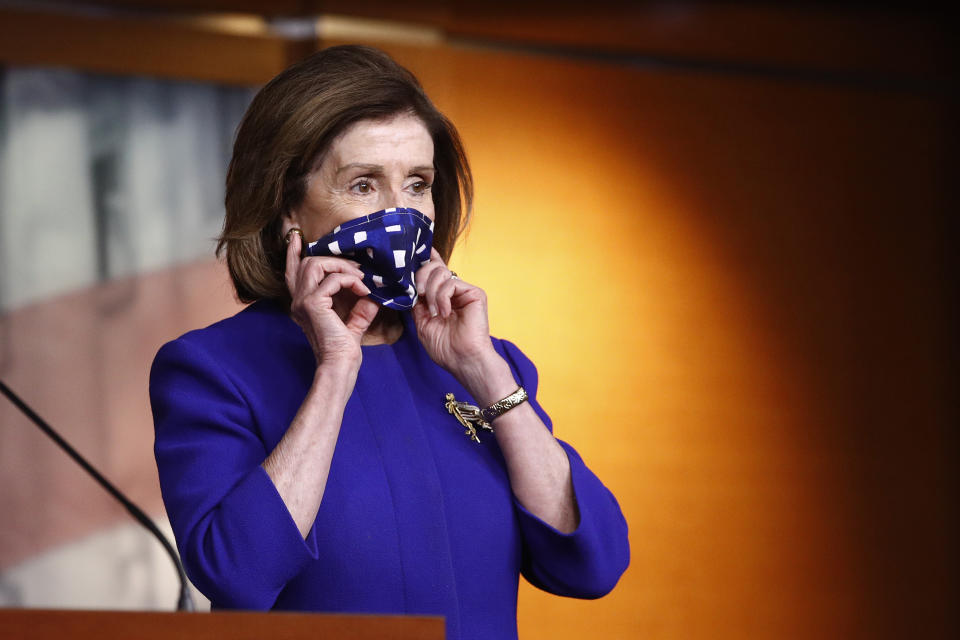 House Speaker Nancy Pelosi of Calif., adjusts her face mask to protect against the spread of the new coronavirus as she attends a news conference to announce members of the House Select Committee on the Coronavirus Crisis on Capitol Hill in Washington, Wednesday, April 29, 2020. (AP Photo/Patrick Semansky)