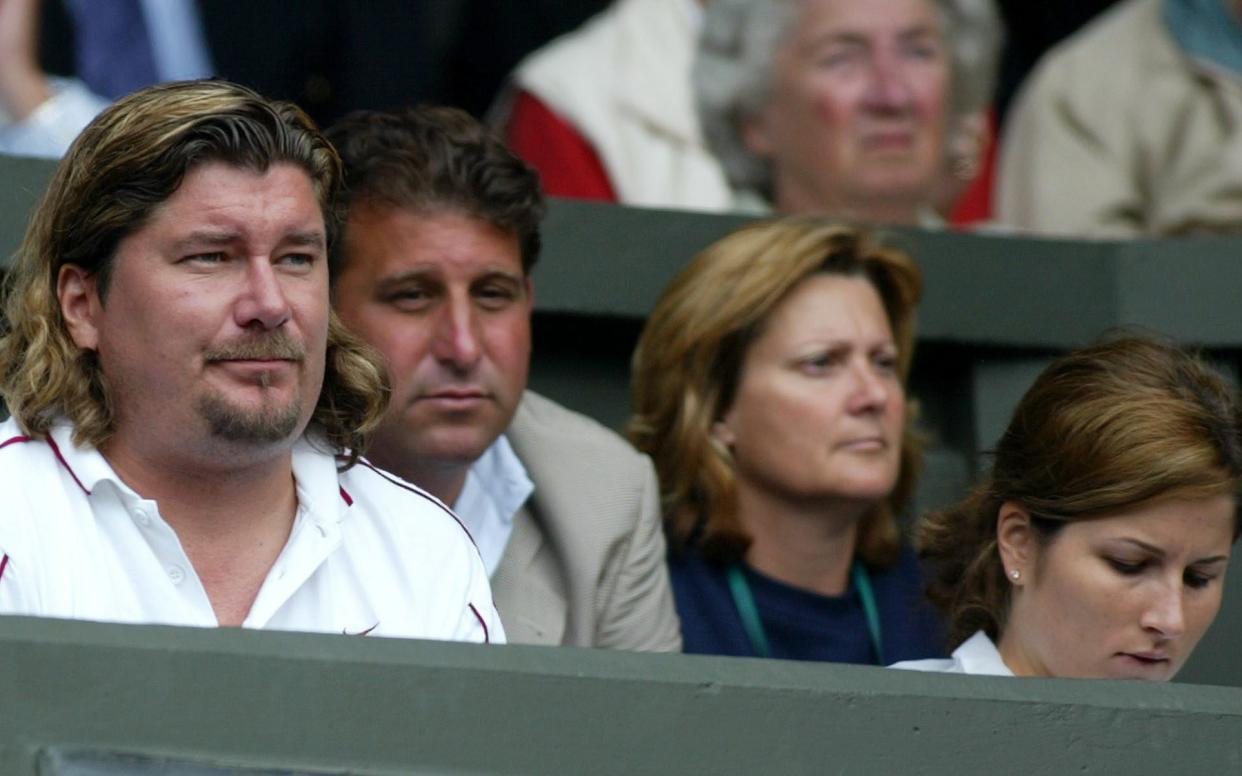 Lundgren, left, watching Roger Federer, 2003