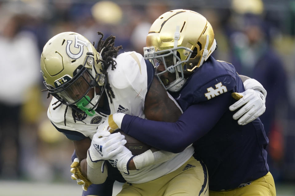 Georgia Tech's Jahmyr Gibbs (1) is tackled by Notre Dame's Clarence Lewis (6) during the first half of an NCAA college football game, Saturday, Nov. 20, 2021, in South Bend, Ind. (AP Photo/Darron Cummings)