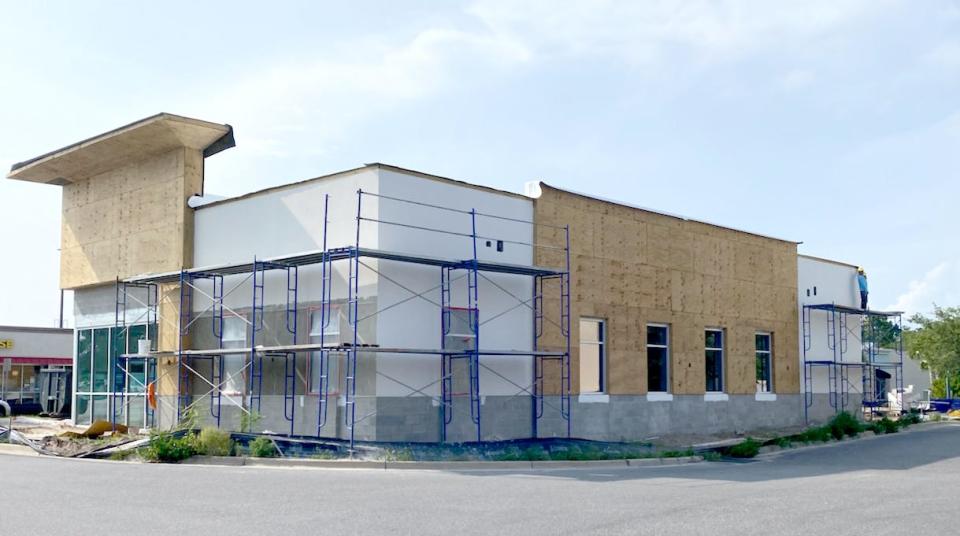 A new dentist's office is being built in the Breakfast Point Marketplace, between AMI Gas Station and Waffle House, which sits next to a Dunkin Donuts.