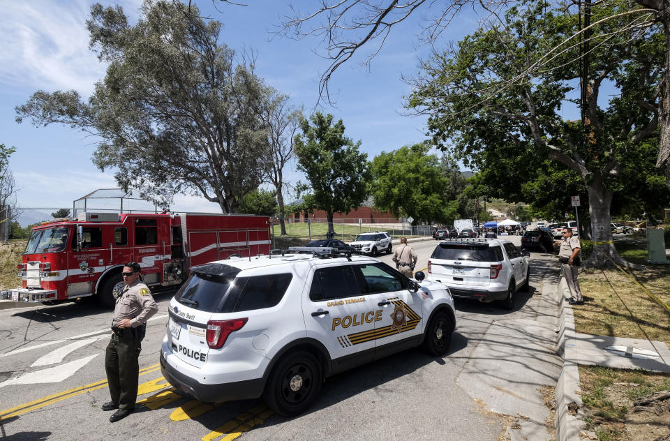 Police officers investigate outside North Park School after a fatal shooting at the elementary school, Monday, April 10, 2017, in San Bernardino, Calif. (AP Photo/Ringo H.W. Chiu)