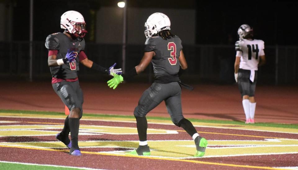 Golden Valley High School senior receiver Jonah White (3) celebrates his second touchdown catch of the night with teammate Josiah McCray (6) during the Cougars’ 21-16 win over Pitman on Friday, Sept. 8, 2023 at Veterans Stadium in Merced, Calif.