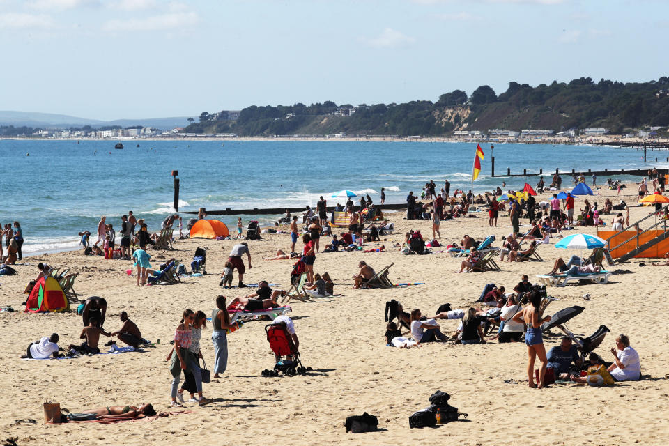 Visitors at Bournemouth beach have taken to the sand to make the most of the hot weekend weather across the UK. (Photo by Jonathan Brady/PA Images via Getty Images)