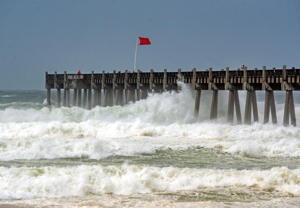 Waves kicked up by Tropical Storm Cristobal crash around the Pensacola Beach Pier on June 7, 2020.