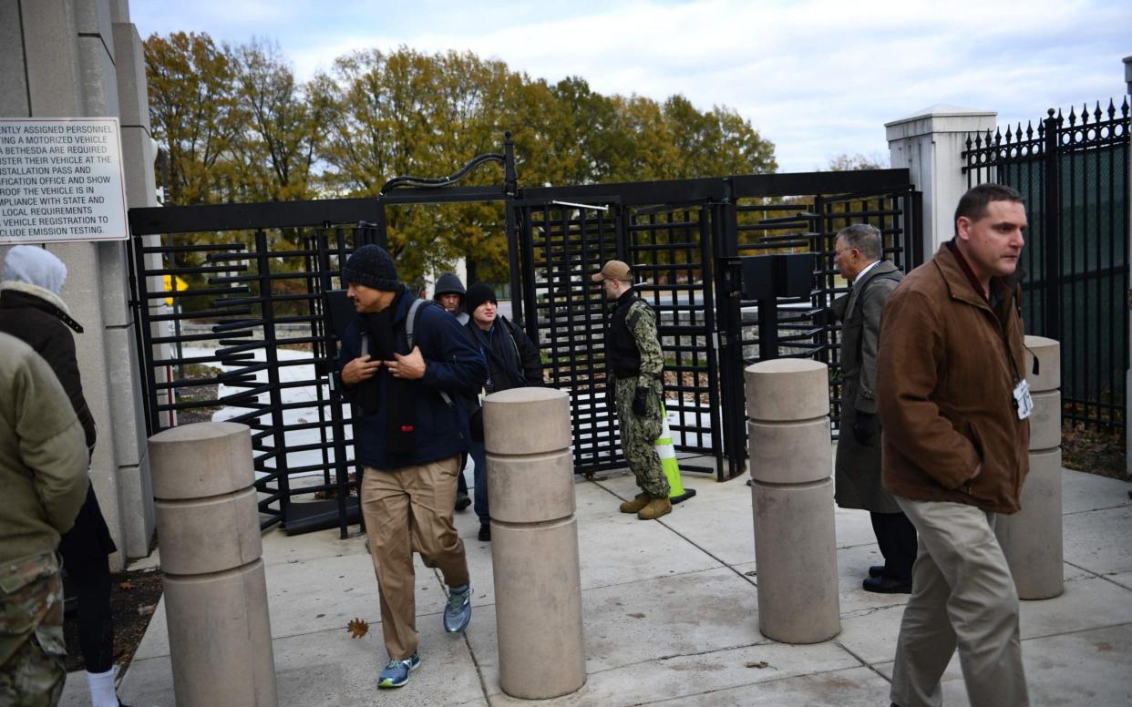 People leave the Walter Reed military medical center during an emergency drill on Tuesday - AFP