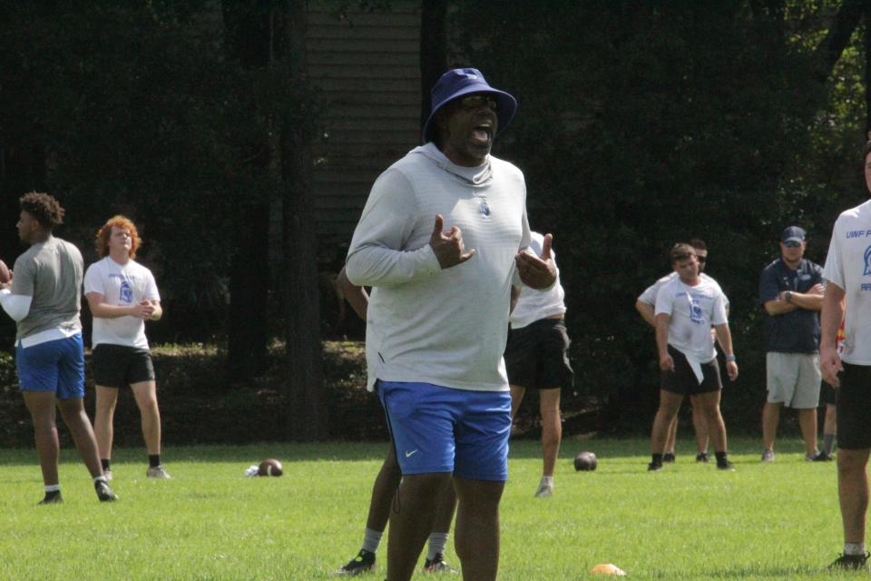 UWF Offensive Coordinator Ron Dickerson Jr. explains a drill to the wide receivers during the UWF football camp on Saturday, July 15, 2023.