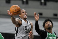 San Antonio Spurs forward DeMar DeRozan (10) scores past Boston Celtics guard Marcus Smart (36) during the second half of an NBA basketball game in San Antonio, Wednesday, Jan. 27, 2021. (AP Photo/Eric Gay)