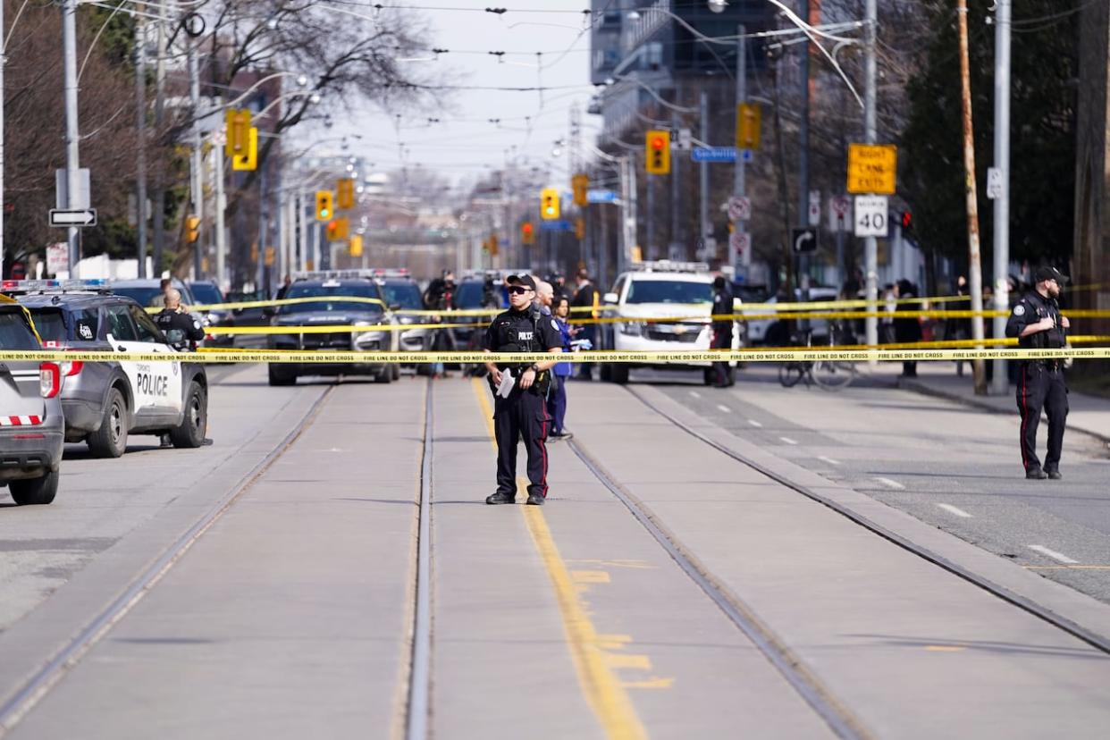 Toronto police said Wednesday a 23-year-old man from Toronto has been arrested and charged after a daytime shooting earlier this week that left two men dead and a woman injured. (Arlyn McAdorey/The Canadian Press - image credit)