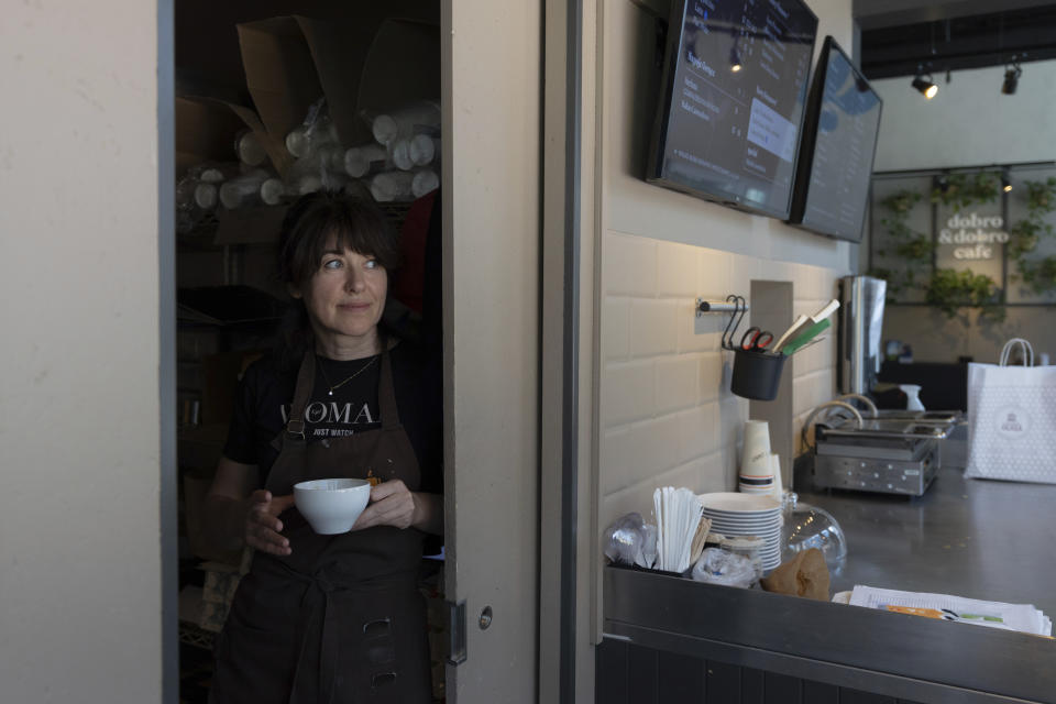 Tetiana Bilous, a Ukrainian refugee from Vinnytsia, poses for a picture in a cafe where she works in the kitchen in Warsaw, Poland, Wednesday, Aug. 17, 2022. As Russia’s war against Ukraine reaches the sixth-month mark, many refugees are coming to the bitter realization that they will not be returning home soon. With shelling around a nuclear power plant and missiles threatening even western regions of Ukraine, many refugees don’t feel safe at home, even if those areas are under Ukrainian control. (AP Photo/Michal Dyjuk)