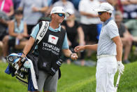 Rickie Fowler, right, talks with his caddie on the ninth green during the third round of the Travelers Championship golf tournament at TPC River Highlands, Saturday, June 24, 2023, in Cromwell, Conn. (AP Photo/Frank Franklin II)