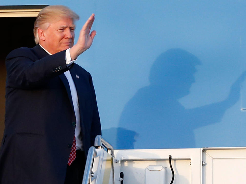 President Donald Trump waves to supporters on the steps of Air Force One: AP