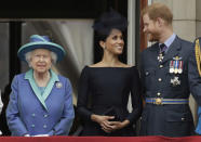 FILE - In this Tuesday, July 10, 2018 file photo Britain's Queen Elizabeth II, and Meghan the Duchess of Sussex and Prince Harry watch a flypast of Royal Air Force aircraft pass over Buckingham Palace in London. In a stunning declaration, Britain's Prince Harry and his wife, Meghan, said they are planning "to step back" as senior members of the royal family and "work to become financially independent." A statement issued by the couple Wednesday, Jan. 8, 2020 also said they intend to "balance" their time between the U.K. and North America. (AP Photo/Matt Dunham, File)