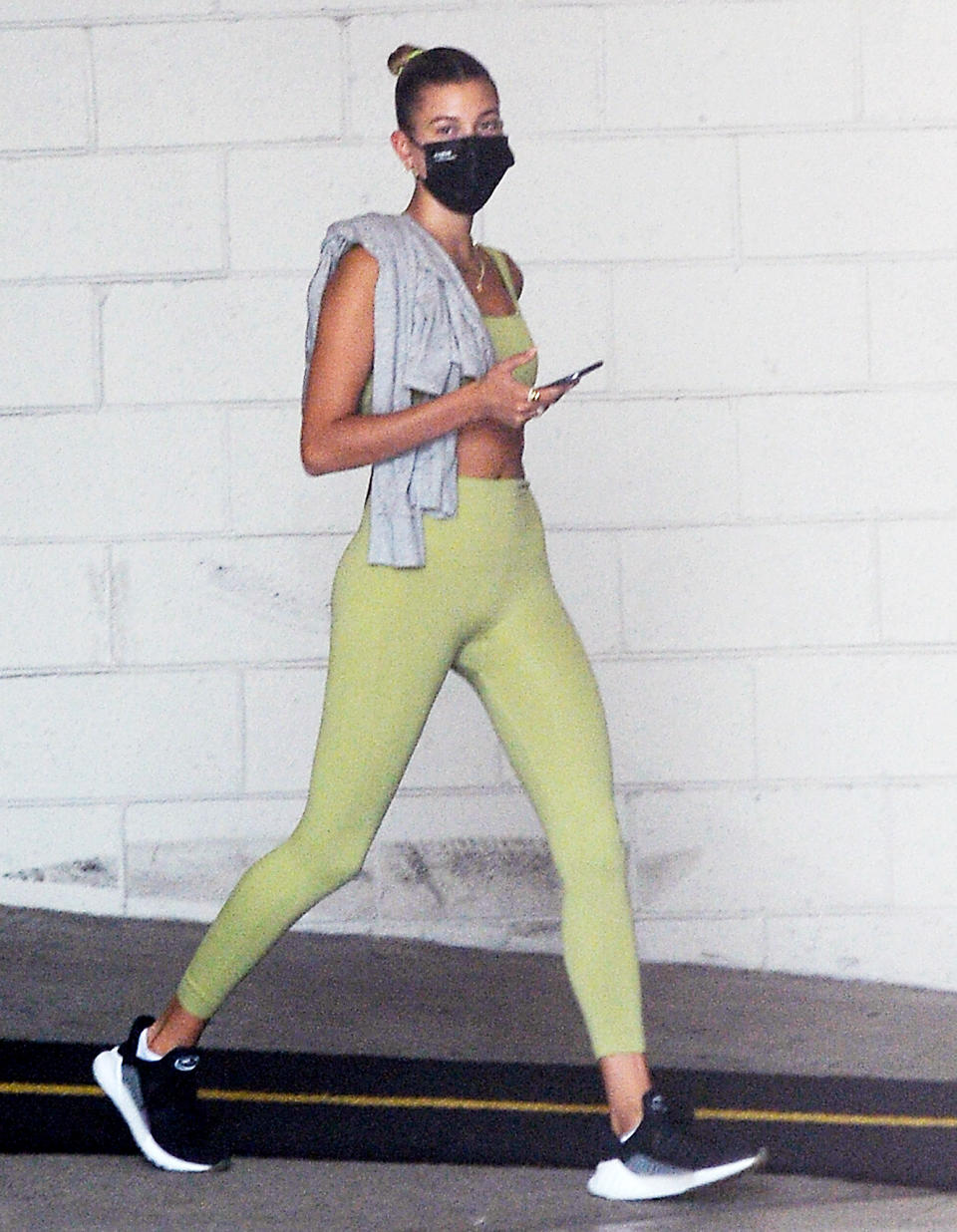 <p>Hailey Bieber wears a lime green workout set while on her way to the gym in L.A. on Friday.</p>