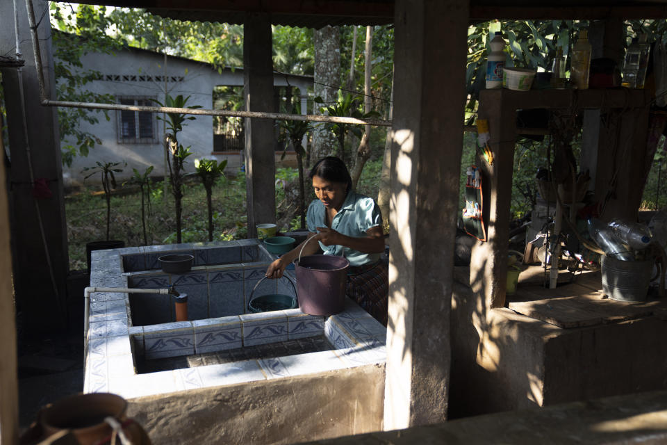 Thelma Cabrera, presidential hopeful for the Movement for the Liberation of the People, MLP, party get water for her plants at her home in El Asintal, Guatemala, Monday, March 13, 2023. Cabrera and the MLP are waiting for the Supreme Electoral Tribunal to approve the candidacy of her running-mate Jordan Rodas, ahead of 2023 general elections. (AP Photo/Moises Castillo)