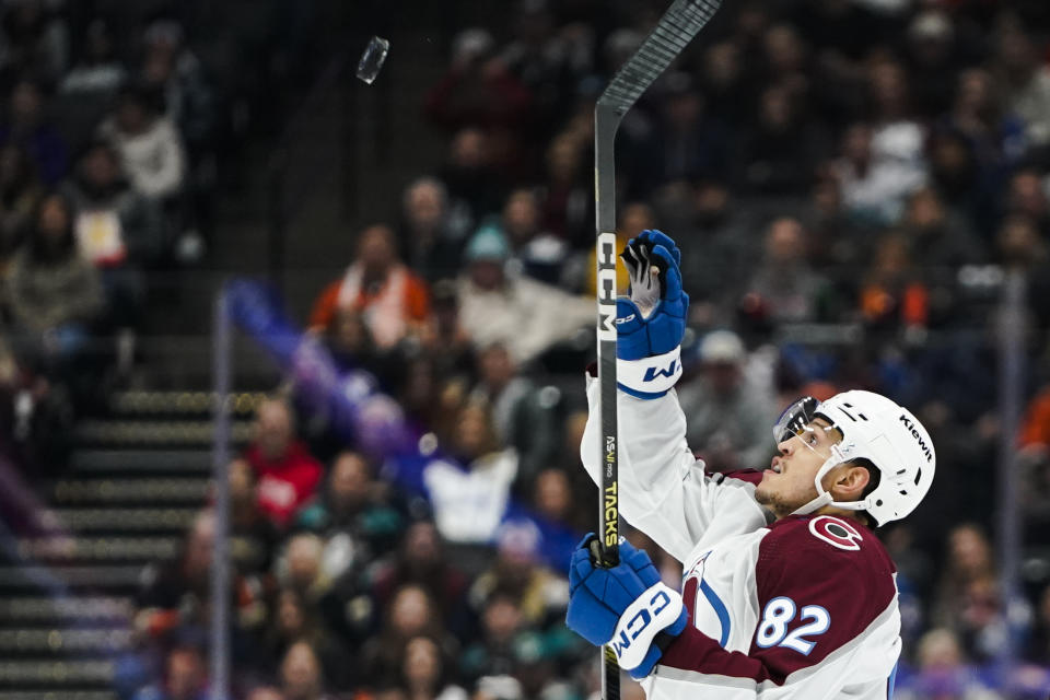 Colorado Avalanche defenseman Caleb Jones prepares to bat an airborne puck during the second period of the team's NHL hockey game against the Anaheim Ducks on Saturday, Dec. 2, 2023, in Anaheim, Calif. (AP Photo/Ryan Sun)