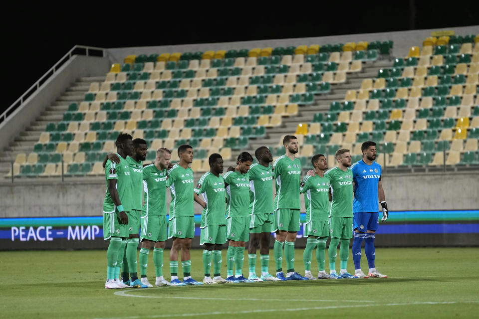 Players of Maccabi Haifa observe a minute of silence for the victims of Hamas attack, before the Europa League group F soccer match between Maccabi Haifa and Villarreal, at AEK arena stadium in Larnaca, Cyprus, on Thursday, Nov. 9, 2023. (AP Photo/Petros Karadjias)