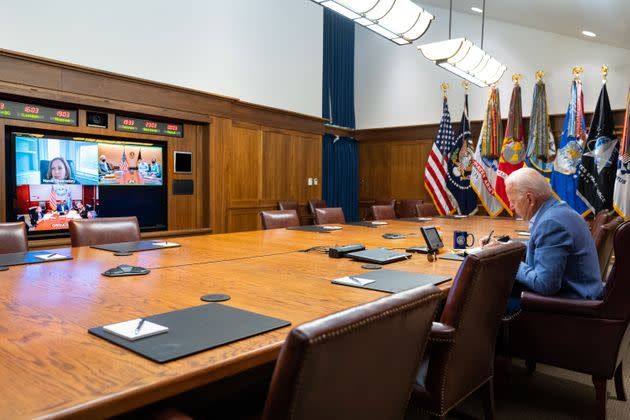 In this White House handout, President Joe Biden and Vice President Kamala Harris (on screen) speak with their national security team about efforts to draw down the civilian footprint in Afghanistan on  Aug. 16, 2021. (Photo: The White House via Getty Images)