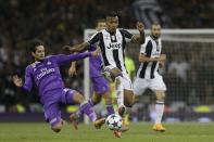<p>Real Madrid’s Isco, left, challenges for the ball with Juventus’ Alex Sandro during the Champions League final soccer match between Juventus and Real Madrid at the Millennium Stadium in Cardiff </p>