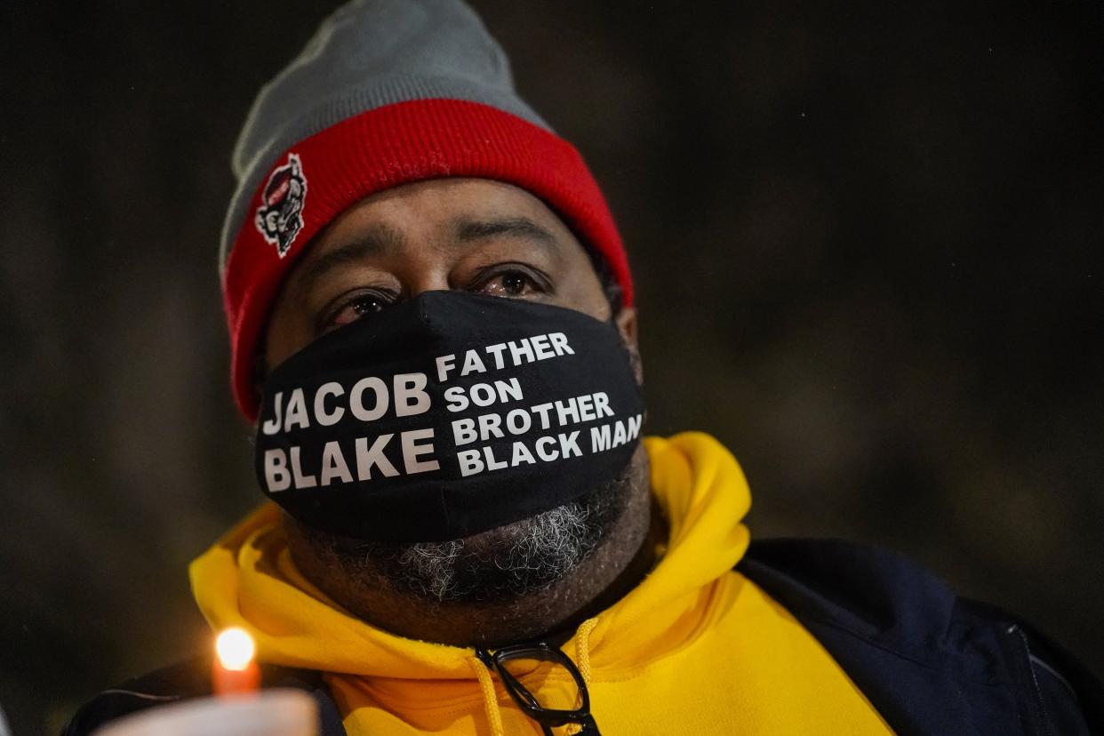 Jacob Blake Sr., father of Jacob Blake, holds a candle at a rally Monday, Jan. 4, 2021, in Kenosha, Wis. (AP Photo/Morry Gash)