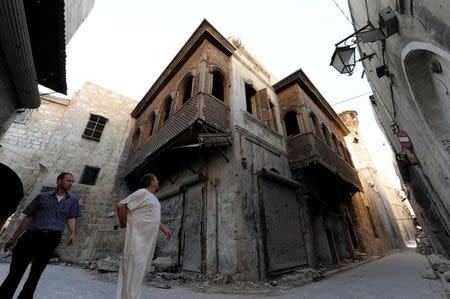 A man looks at a Mashrabiya in the old city of Aleppo, Syria July 13, 2017. Picture taken July 13, 2017. REUTERS/Omar Sanadiki