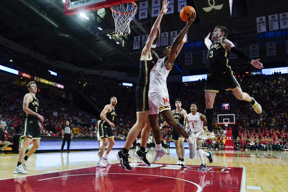 Maryland forward Julian Reese, center right, goes up for a shot against Purdue center Zach Edey, center, and guard Braden Smith, right, during the second half of an NCAA college basketball game, Thursday, Feb. 16, 2023, in College Park, Md. Maryland won 68-54. (AP Photo/Julio Cortez)