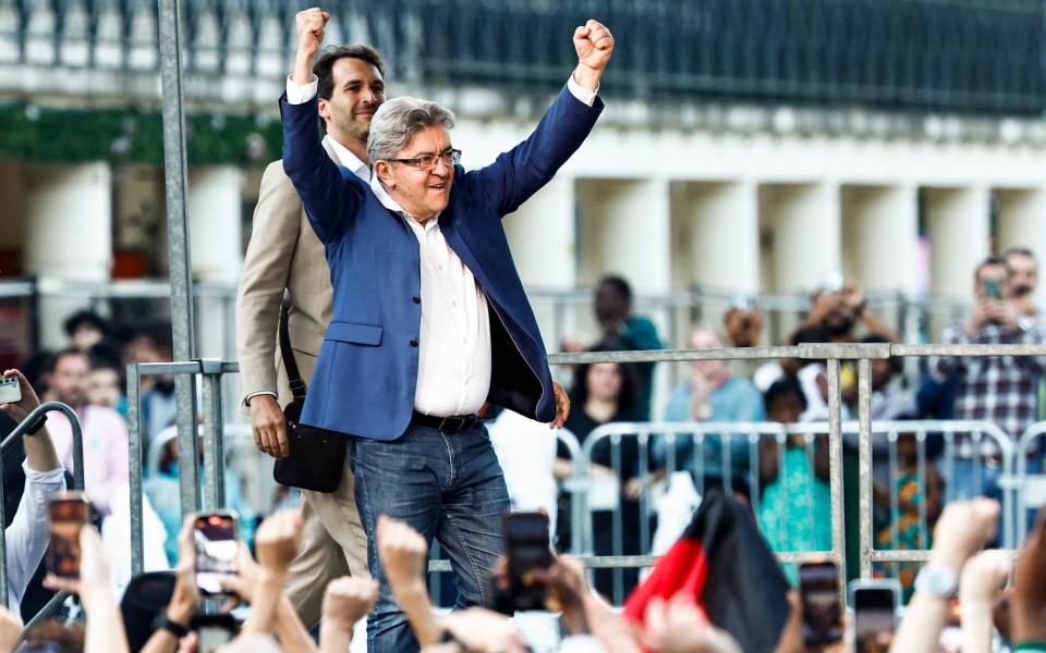 France Unbowed founder Jean-Luc Melenchon punches the air as he reacts to the projected election results