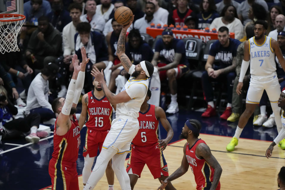 Los Angeles Lakers forward Anthony Davis shoots over New Orleans Pelicans center Jonas Valanciunas, guard Jose Alvarado (15), forward Herbert Jones (5) and forward Naji Marshall in the first half of an NBA basketball game in New Orleans, Saturday, Feb. 4, 2023. (AP Photo/Gerald Herbert)