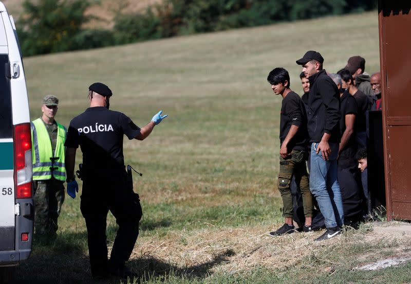 Migrants board a van after being detained by Slovakian police, close to the Slovakia-Hungary border in the village of Chl'aba