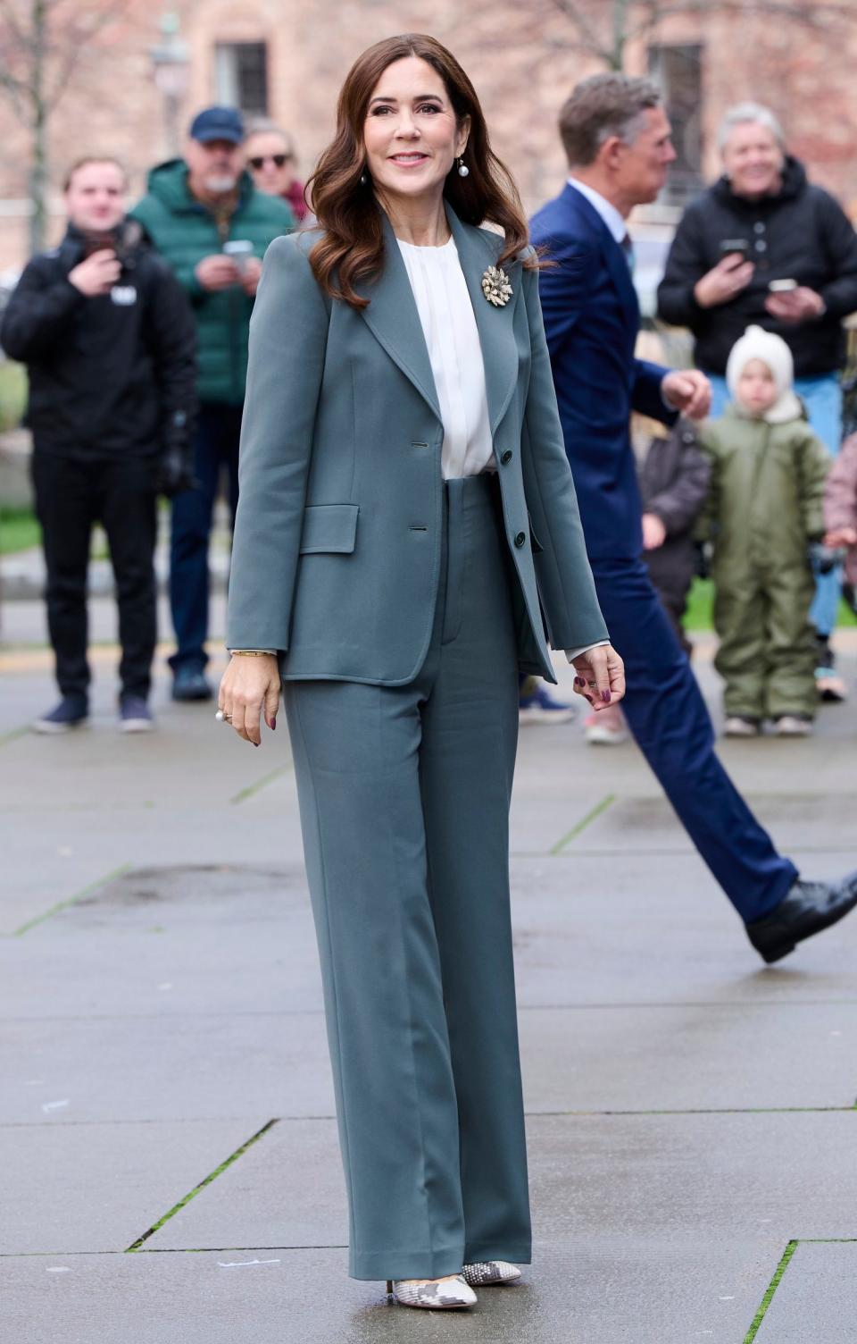 Queen Mary in a green suit