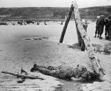 A dead American soldier lies face down on a Normandy, France, beach following the 1944 D-Day invasion. (Photo: Three Lions/Getty Images)