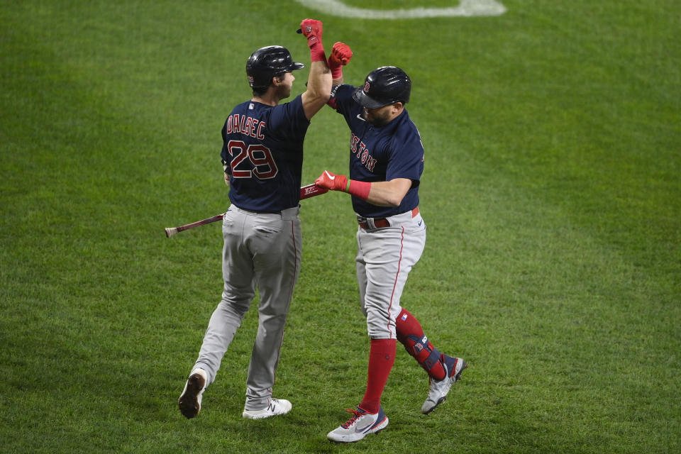 Boston Red Sox' Kyle Schwarber, right, celebrates his home run with Bobby Dalbec (29) during the second inning of a baseball game against the Baltimore Orioles, Tuesday, Sept. 28, 2021, in Baltimore. (AP Photo/Nick Wass)