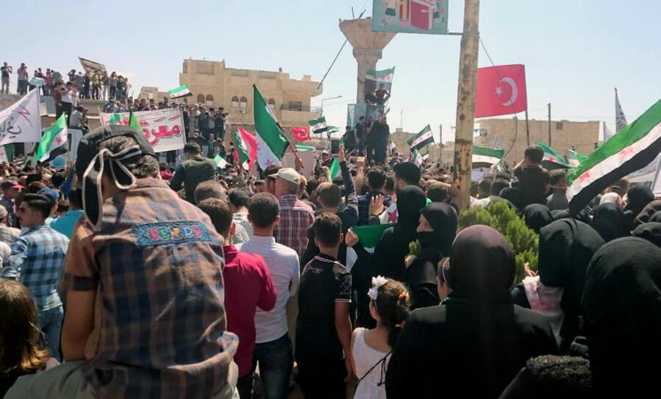 This image courtesy of Wissam Zarqa, an activist and resident of Idlib, shows protesters holding Syrian revolution and Turkish flags, in Maaret al-Numan, a town in Idlib province, Syria, Friday, Sept 7, 2018. The rallies were a day of protests against Syrian President Bashar Assad and his troops' imminent offensive against Idlib, the last bastion of rebels in Syria. The Friday rallies came as Presidents of Iran, Turkey and Russia are meeting in Tehran to discuss the war in Syria. The summit may determine whether diplomacy halts any military action in Idlib and its surrounding areas, home to more than 3 million people. Nearly half of the area's residents are already displaced from other parts of Syria and have refused to reconcile with the Syrian government. (Courtesy of Wissam Zarqa via AP)