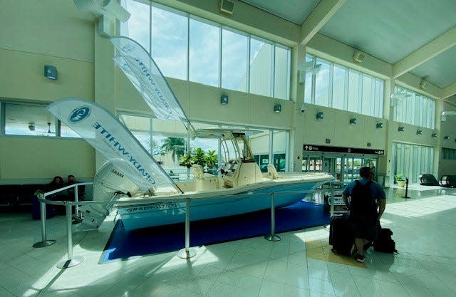 This is one of the fishing boats from Fish Tale Boats Fort Myers & Naples on display in the main terminal at Southwest Florida International Airport in Fort Myers.